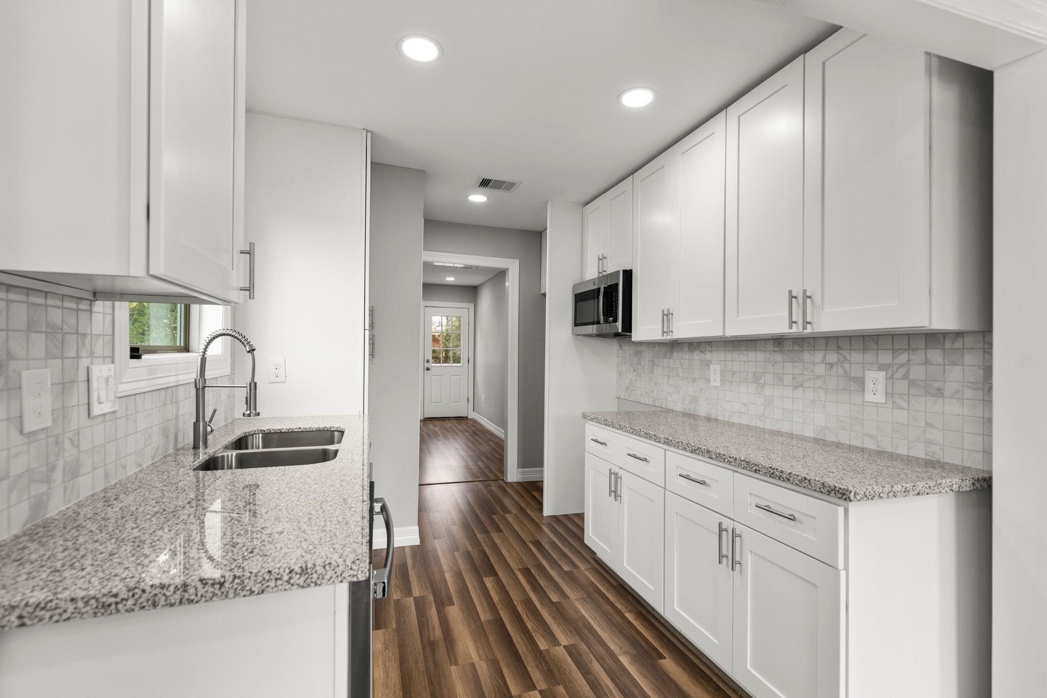 5210 Pickfair Street Houston, TX 77026 - Photo 7 of 18 a kitchen with stainless steel appliances granite countertop a sink stove and refrigerator
