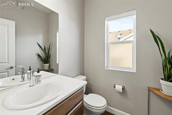 a bathroom with a sink a toilet and mirror