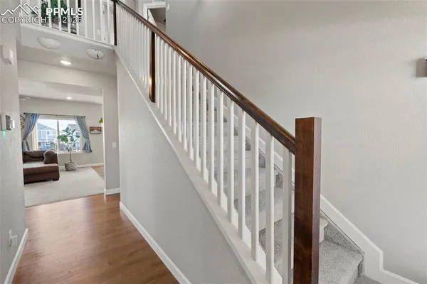 a view of entryway and hall with wooden floor