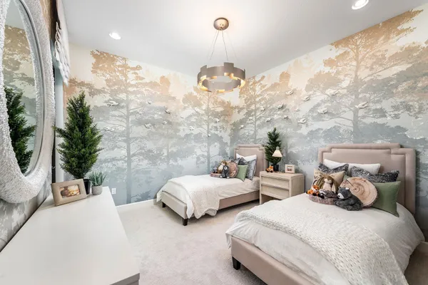 a spacious bedroom with two beds and potted plant