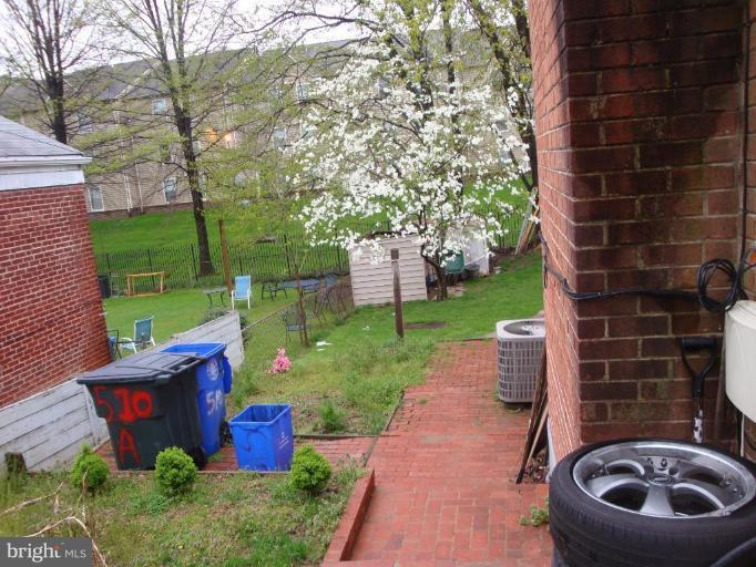510 Royalton Road Silver Spring, MD 20901 - Photo 14 of 14 a view of a backyard with table and chairs potted plants and a fire pit