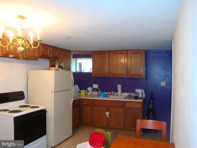 510 Royalton Road Silver Spring, MD 20901 - Photo 5 of 14 a kitchen with refrigerator and cabinets