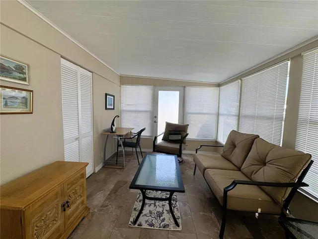 a living room with furniture a rug and a window