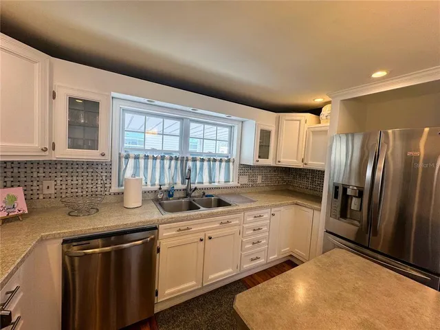 a kitchen that has a sink and a stove