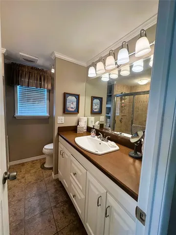 a spacious bathroom with a double vanity sink and a mirror