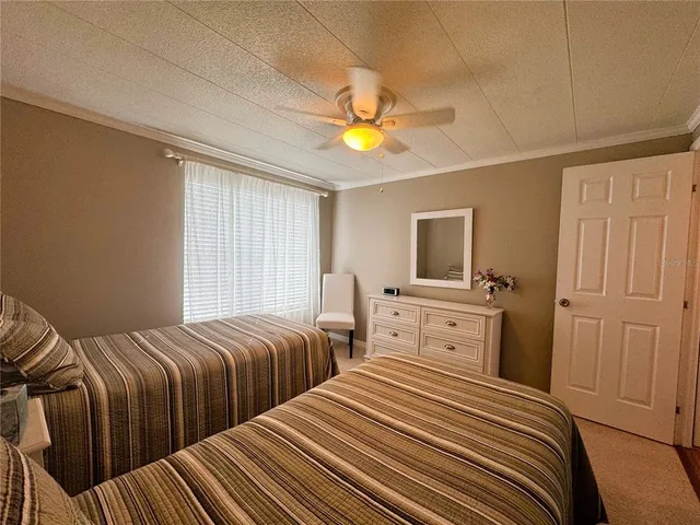 a bedroom with two beds and a chandelier