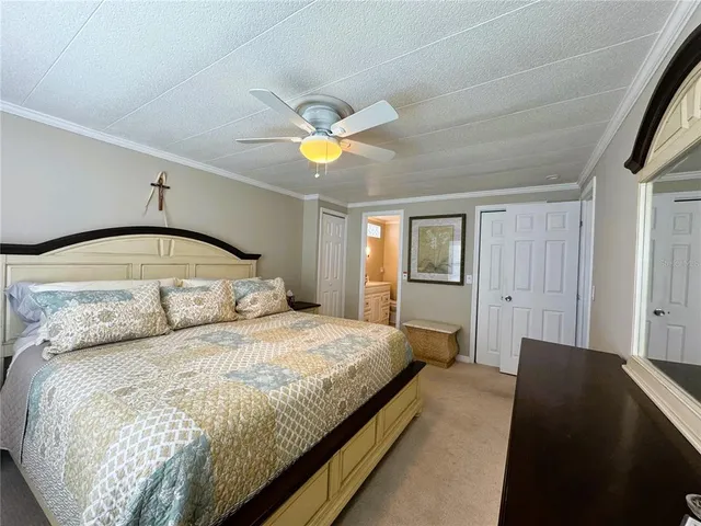 a bedroom with a large bed and a chandelier