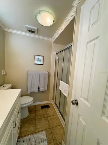 a bathroom with a sink a toilet a mirror and shower
