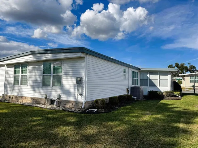 a front view of a house with a garden and yard