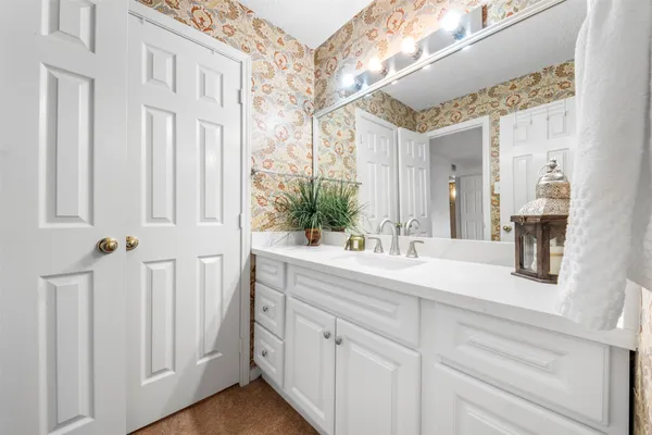 a bathroom with a double vanity sink and a mirror