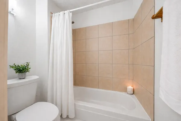 a bathroom with a toilet and a shower