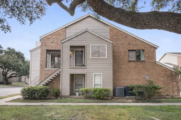 a view of a white house next to a yard