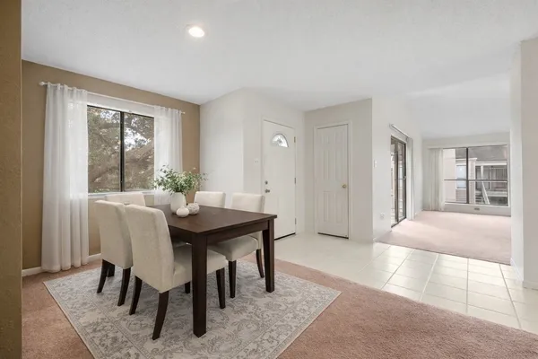 a view of a dining room with furniture and window