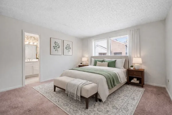 a bedroom with a bed and a couch