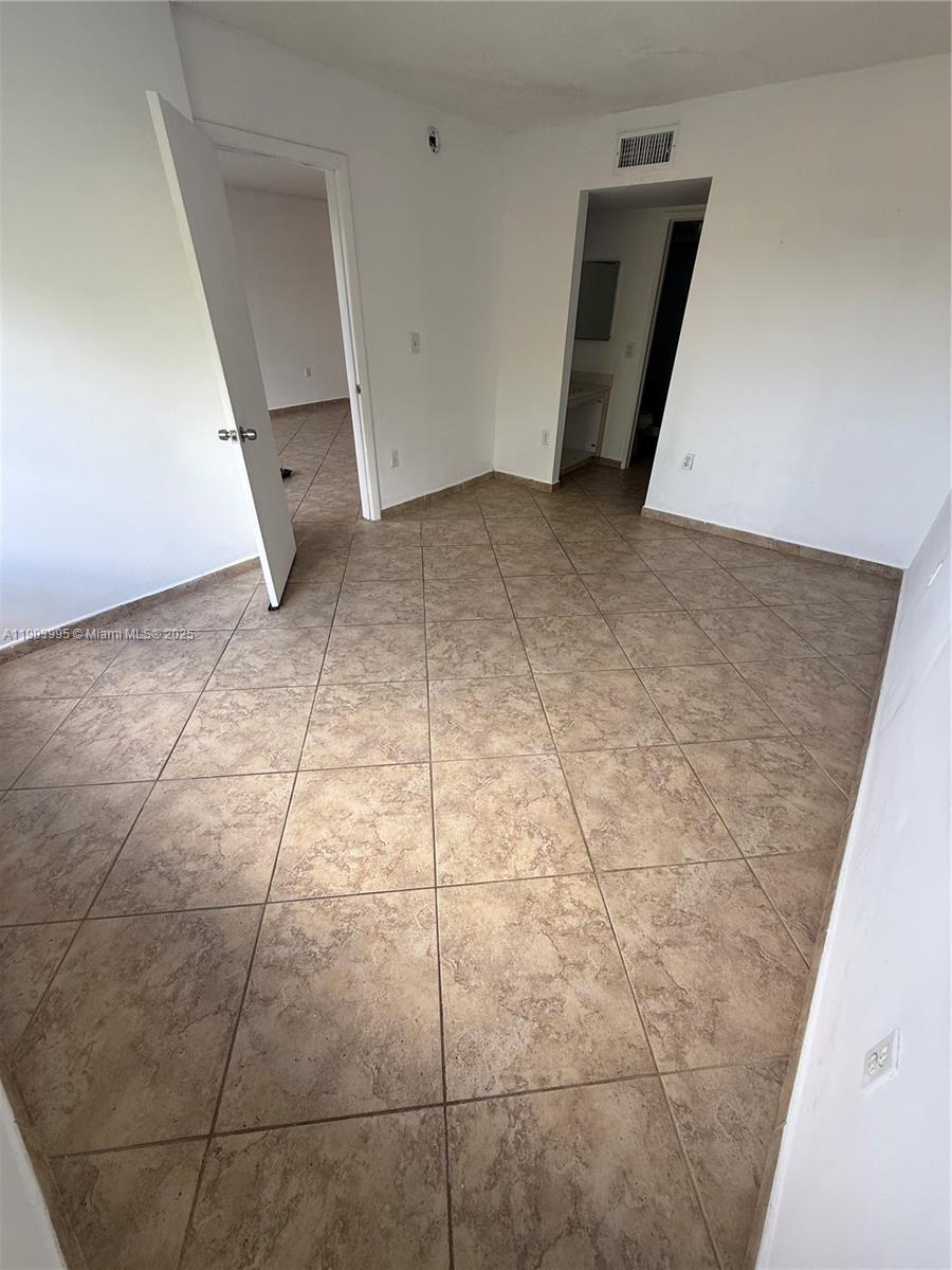 10253 Northwest 9th St Circle, Unit 4066 Miami, FL 33172 - Photo 18 of 27 a view of a room with an empty space