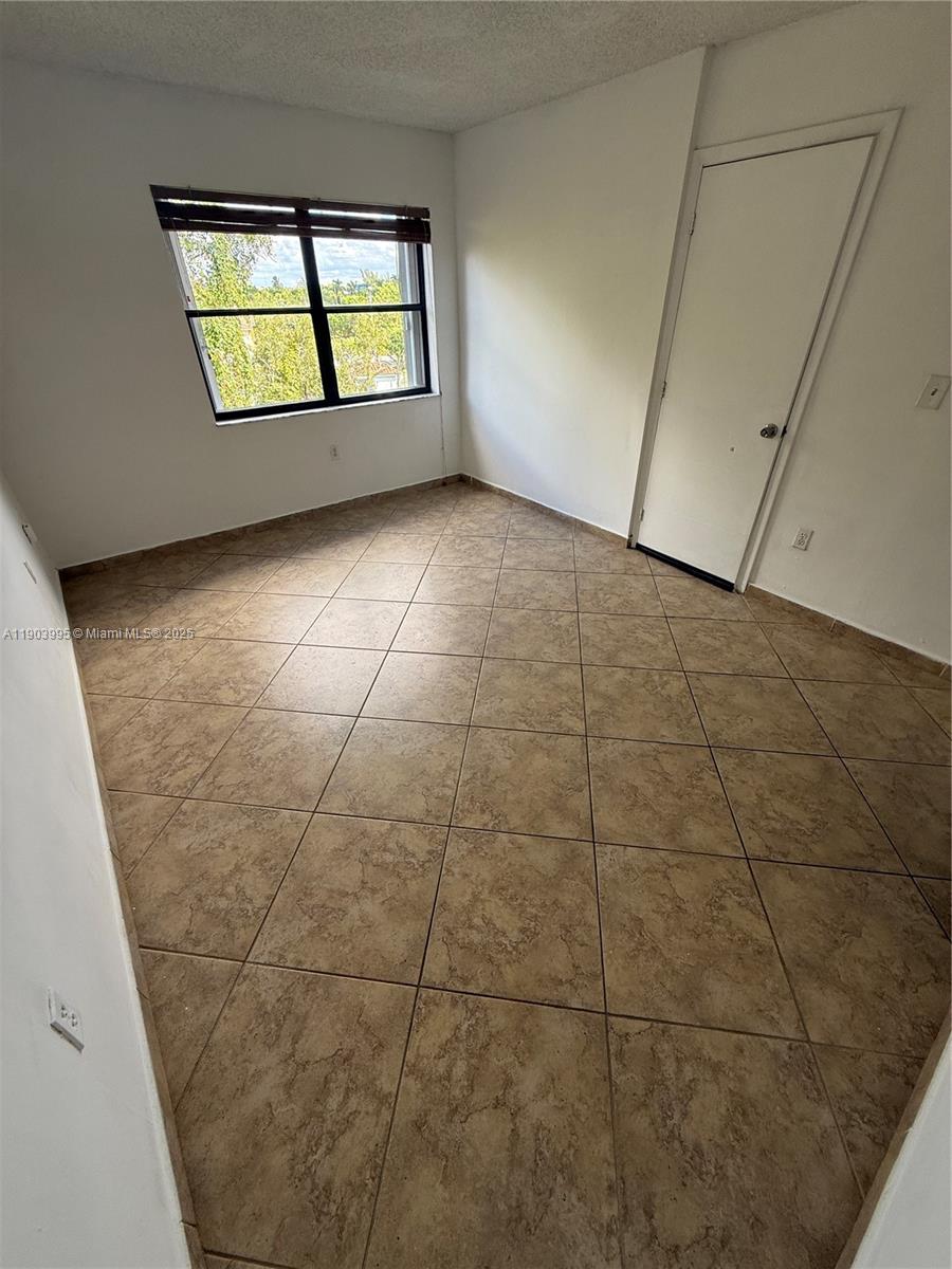 10253 Northwest 9th St Circle, Unit 4066 Miami, FL 33172 - Photo 19 of 27 a view of an empty room with windows