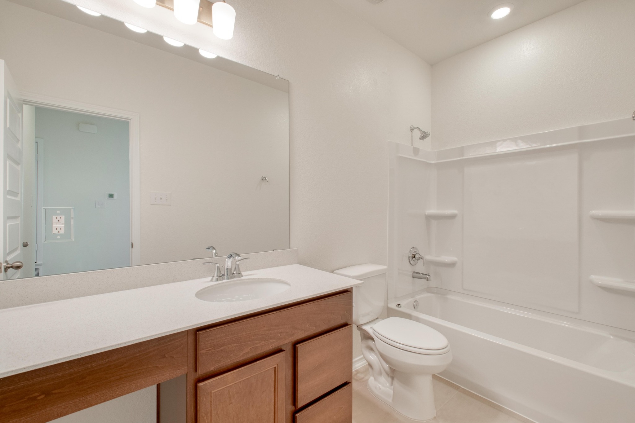 280 Feathers Street Jarrell, TX 76537 - Photo 23 of 28 a bathroom with a sink a toilet and shower