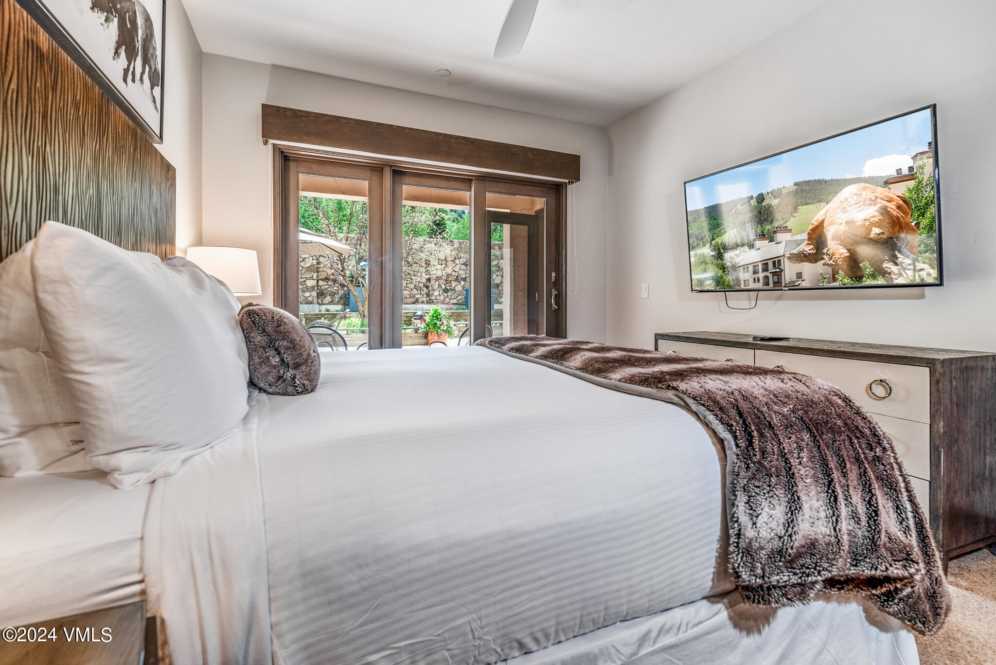 120 Offerson Road, Unit F230 Beaver Creek, CO 81620 - Photo 18 of 48 a bedroom with a bed and wooden floor