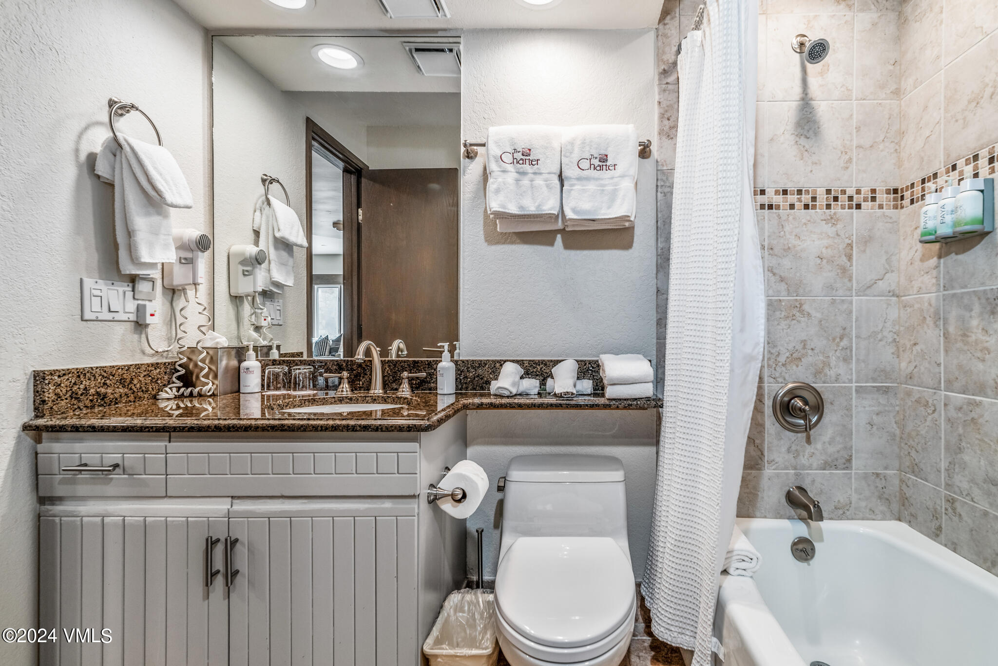 120 Offerson Road, Unit F230 Beaver Creek, CO 81620 - Photo 20 of 48 a bathroom with a granite countertop toilet sink and mirror