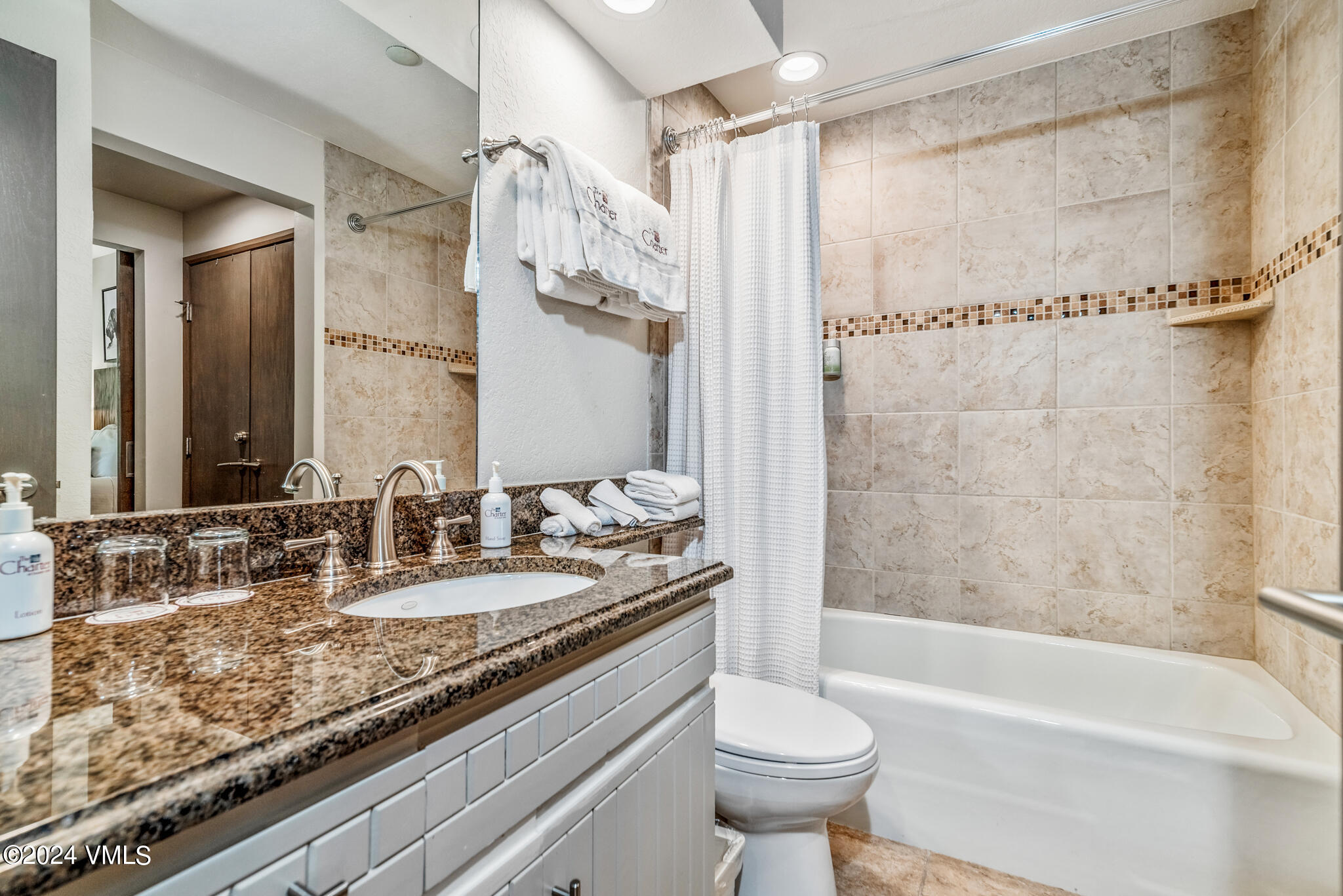 120 Offerson Road, Unit F230 Beaver Creek, CO 81620 - Photo 21 of 48 a bathroom with a granite countertop sink mirror toilet and bathtub