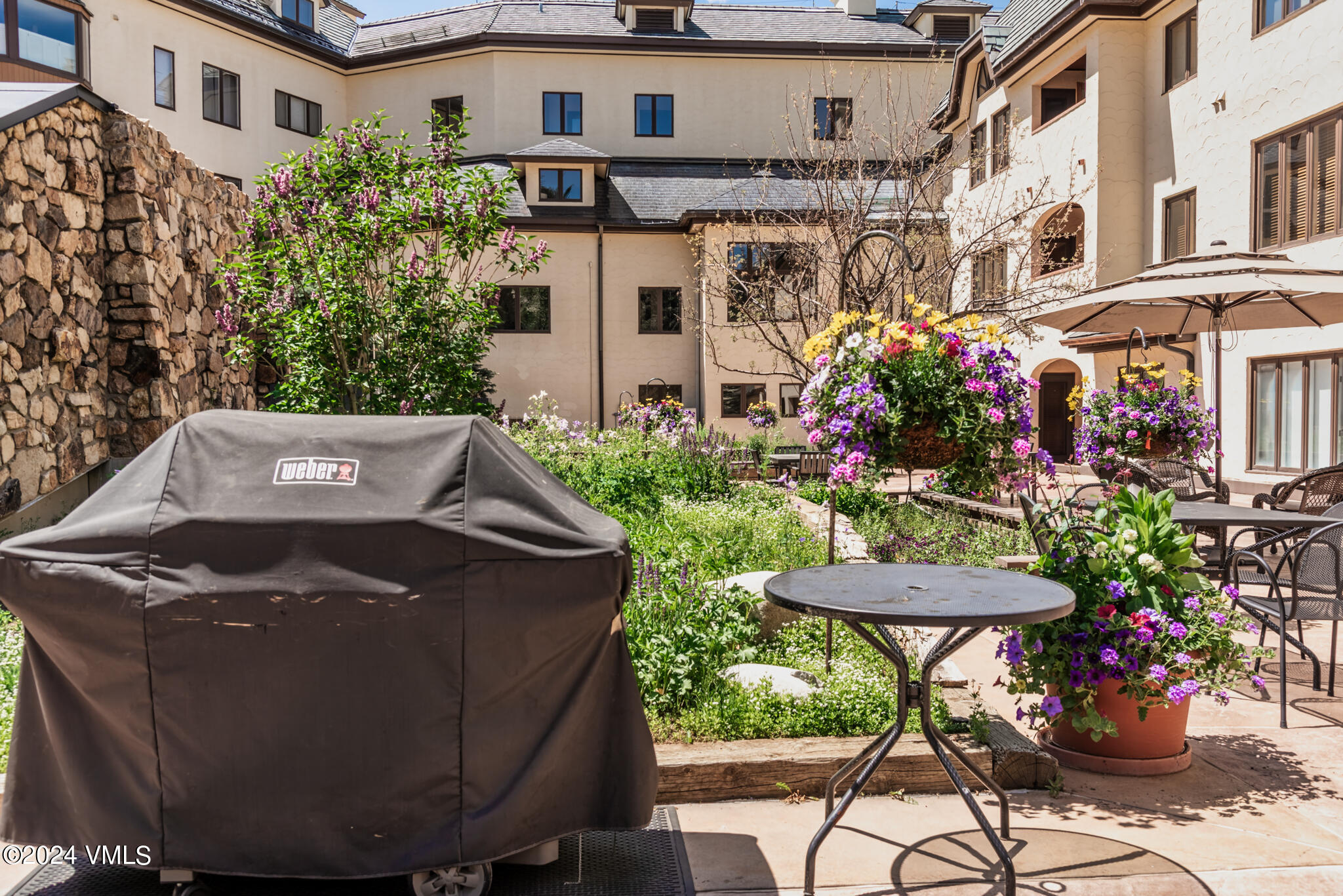 120 Offerson Road, Unit F230 Beaver Creek, CO 81620 - Photo 4 of 48 a front view of a house with a yard and sitting area