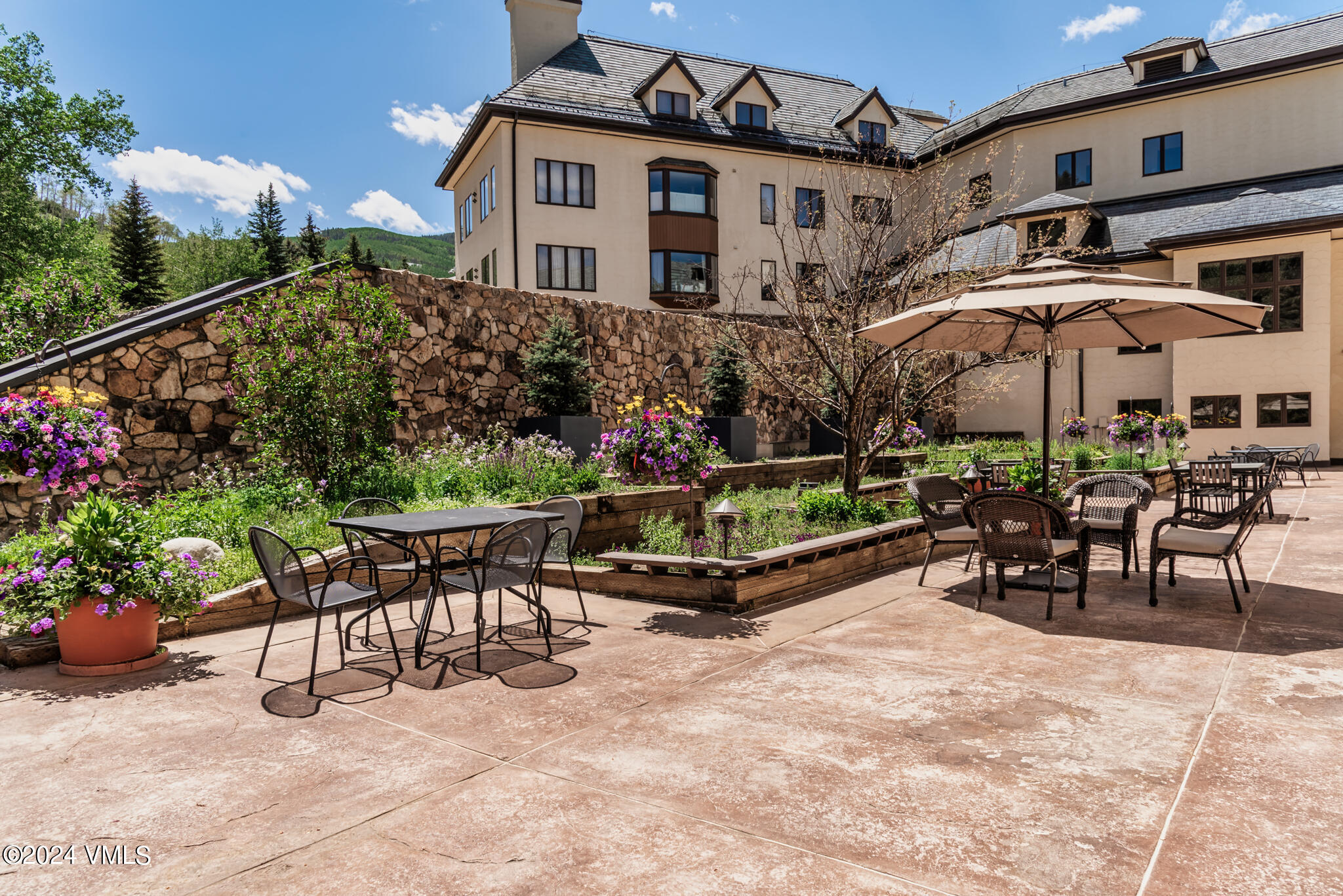 120 Offerson Road, Unit F230 Beaver Creek, CO 81620 - Photo 43 of 48 a view of a chairs and tables in the back yard of the house