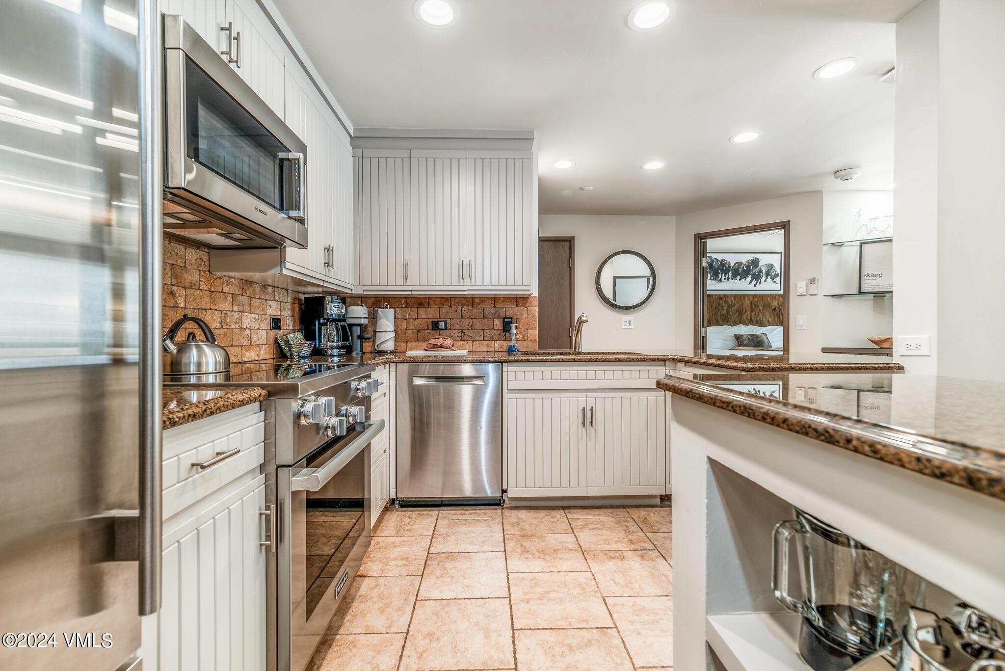 120 Offerson Road, Unit F230 Beaver Creek, CO 81620 - Photo 10 of 48 a kitchen with white cabinets stainless steel appliances and a sink