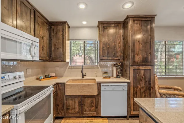 a utility room with cabinets washer and dryer