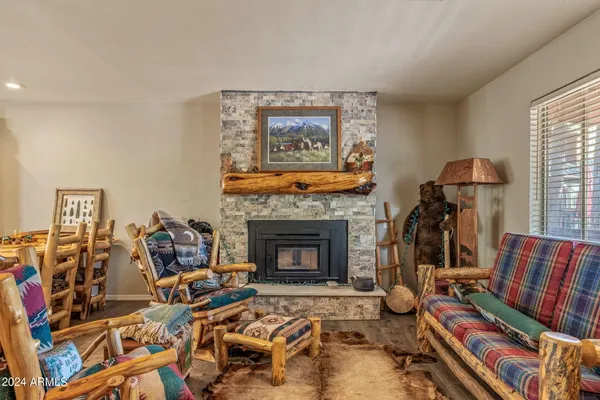 a living room with furniture a fireplace and a window