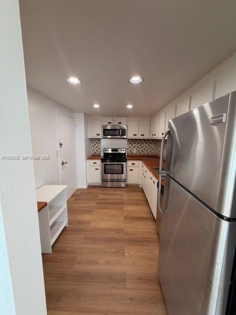 150 Southeast 25th Road, Unit 6A Miami, FL 33129 - Photo 13 of 20 a kitchen with stainless steel appliances a refrigerator and a stove top oven