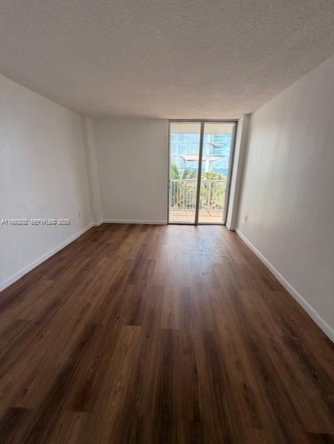 150 Southeast 25th Road, Unit 6A Miami, FL 33129 - Photo 14 of 20 a view of an empty room with wooden floor and a window
