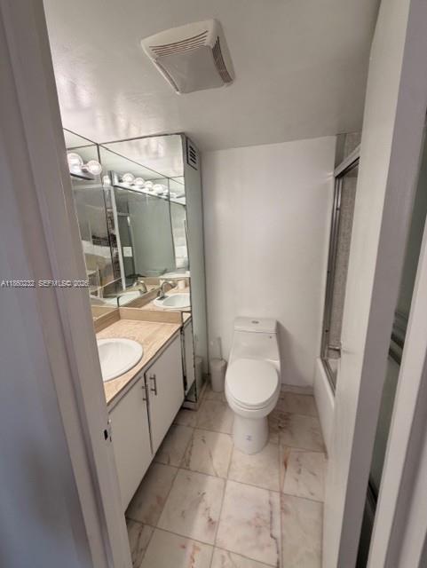 150 Southeast 25th Road, Unit 6A Miami, FL 33129 - Photo 16 of 20 a bathroom with a granite countertop sink toilet and shower