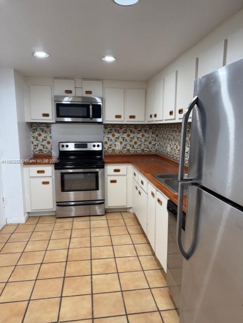 150 Southeast 25th Road, Unit 6A Miami, FL 33129 - Photo 4 of 9 a kitchen with stainless steel appliances granite countertop a stove a sink and a refrigerator