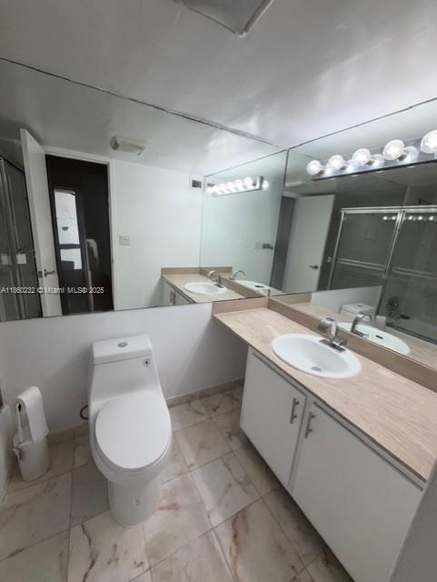 150 Southeast 25th Road, Unit 6A Miami, FL 33129 - Photo 7 of 9 a bathroom with a toilet sink and mirror