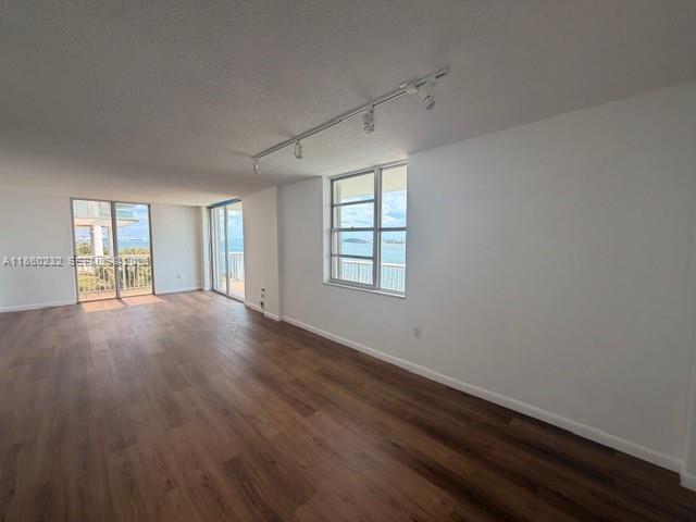 150 Southeast 25th Road, Unit 6A Miami, FL 33129 - Photo 9 of 20 an empty room with wooden floor and windows