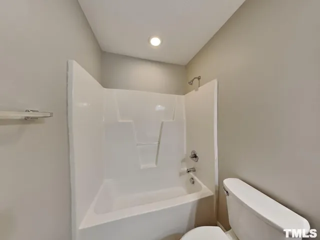 a bathroom with a toilet and a bathtub