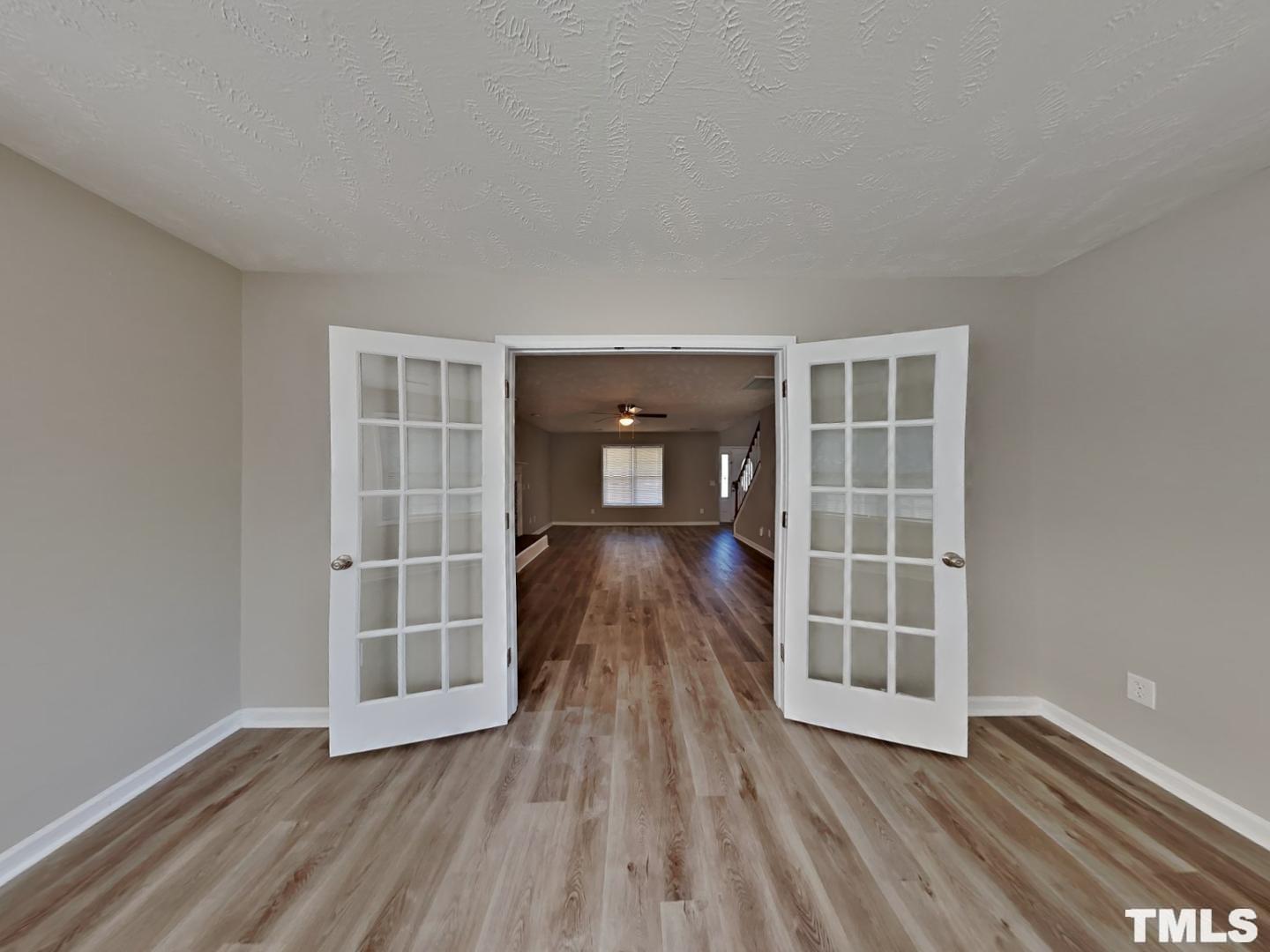 200 Lattimore Road Cameron, NC 28326 - Photo 17 of 19 an empty room with wooden floor and windows