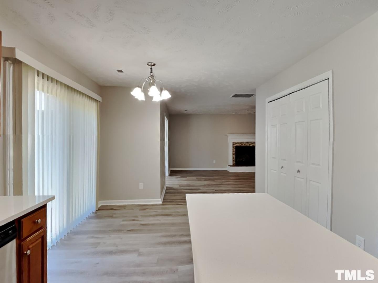 200 Lattimore Road Cameron, NC 28326 - Photo 4 of 19 a bedroom with a bed and a chandelier