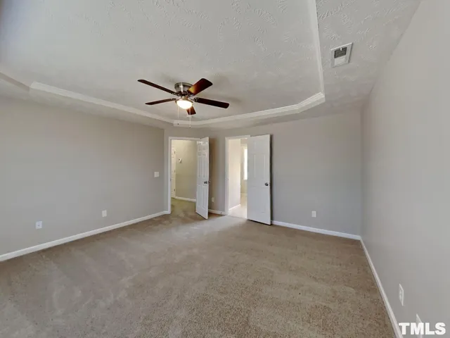 a view of an empty room with a ceiling fan