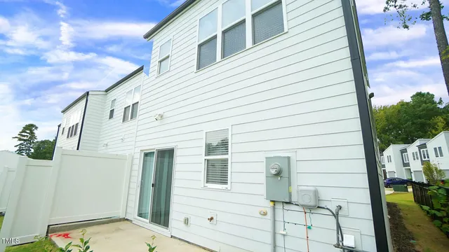 a view of a house with backyard and sitting area
