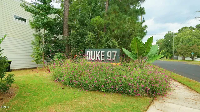 a view of a sign board with garden