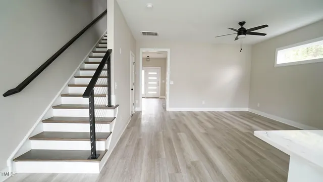 wooden floor in an empty room with a window