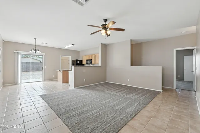 a view of a kitchen with wooden cabinet and a ceiling fan