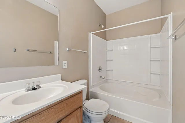 a bathroom with a bathtub shower sink vanity mirror and toilet