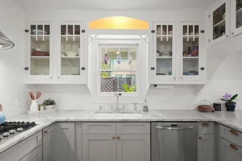 a kitchen with stainless steel appliances granite countertop a sink and cabinets