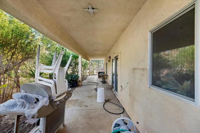 a view of a chairs and table in backyard of the house