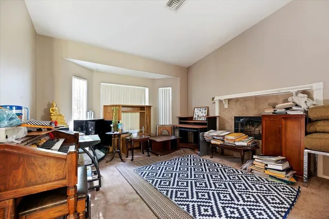 a living room with furniture a fireplace and a window