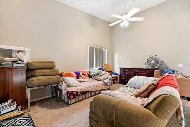 a bedroom with two beds and a chandelier