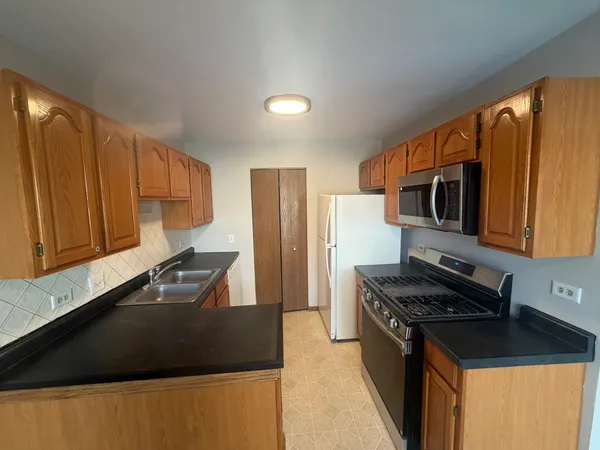 a kitchen with granite countertop a stove and a sink