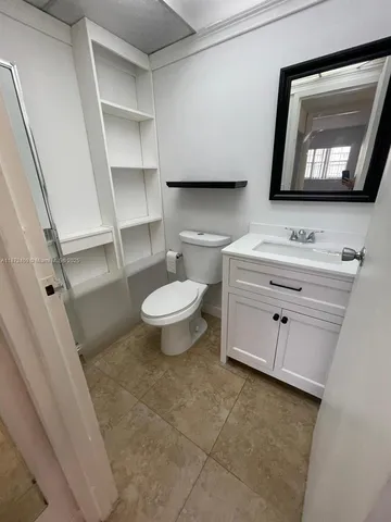 a bathroom with a toilet a sink and mirror